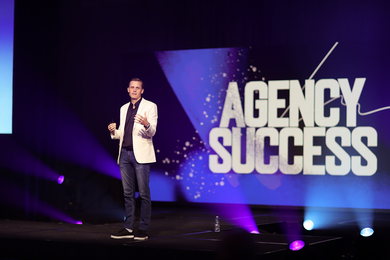 Grant Botma speaking on stage